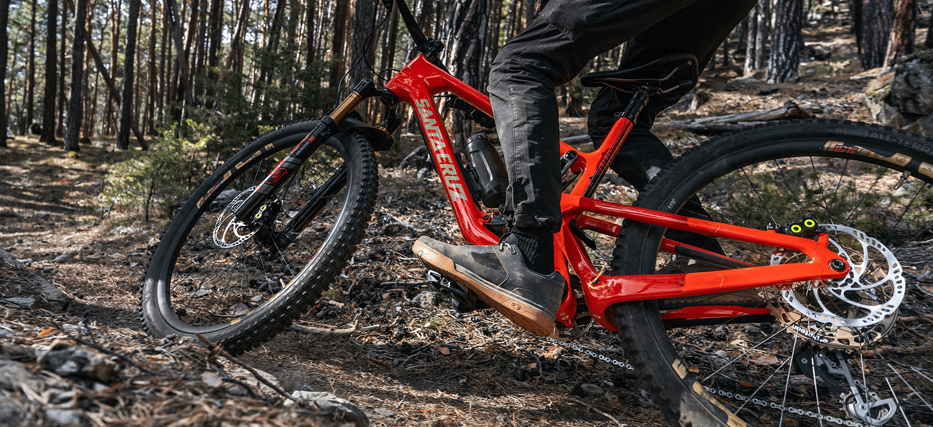 Mountain bike with MAGURA MT5 Pro 4-piston disc brake on a trail.